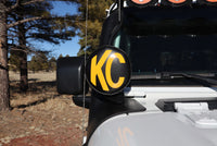Thumbnail for KC HiLiTES 6in. Round Soft Cover (Pair) - Black w/Yellow KC Logo